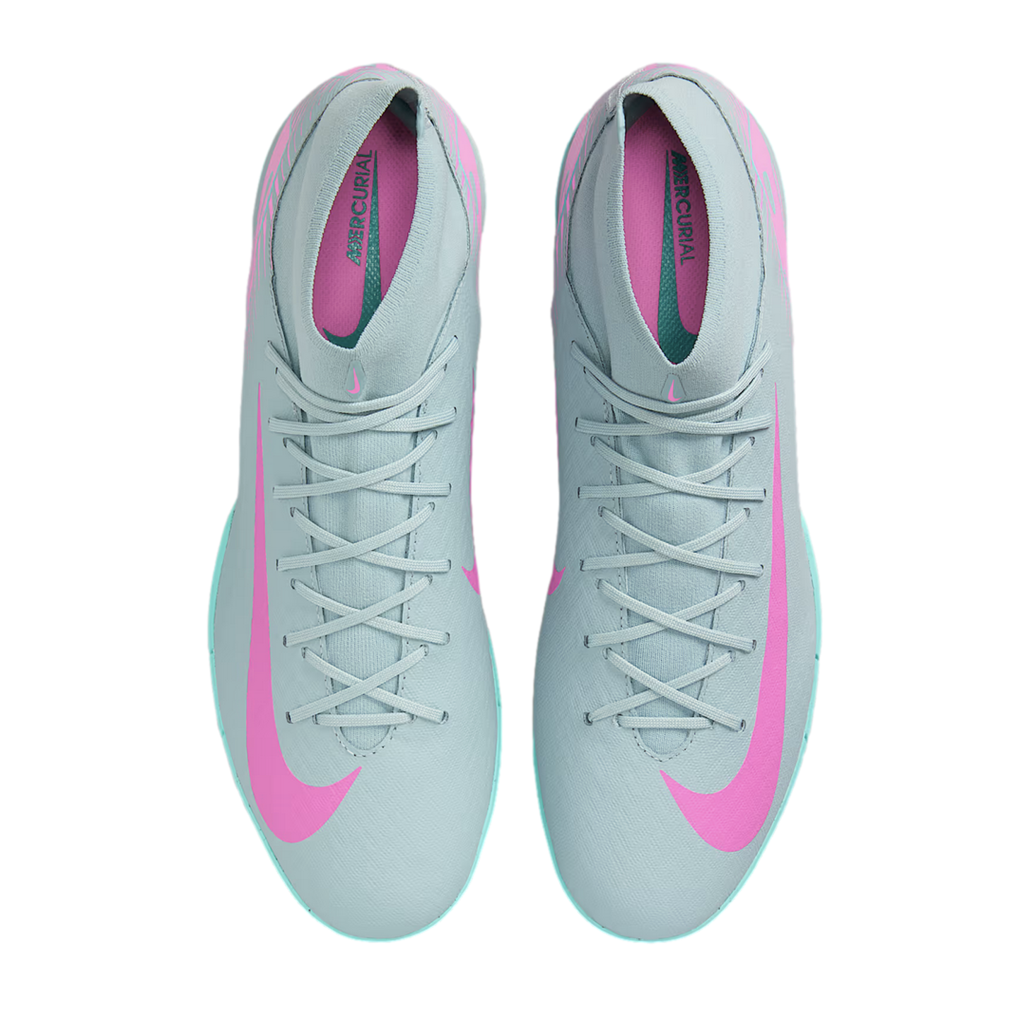 Top-down view of grey Nike Mercurial soccer shoes with pink Nike swooshes and teal accents along the soles.