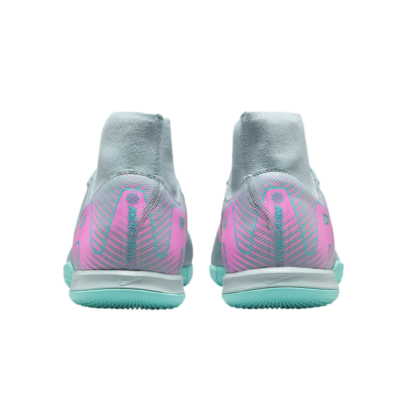 Rear view of two grey Nike Mercurial indoor soccer shoes with pink patterned heels and bright teal outsoles.