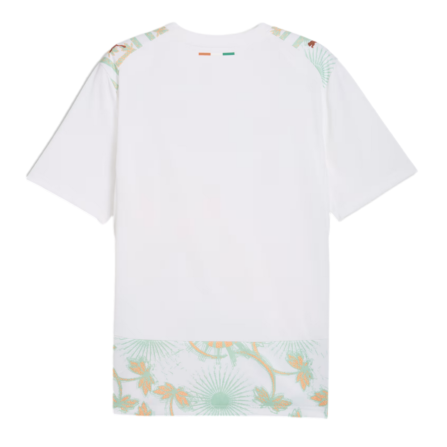 A back view of a white soccer jersey featuring a small orange, white, and green flag on the back of the neck. Light green and gold floral patterns decorate the shoulders and bottom hem, with gold Puma logos on each shoulder.