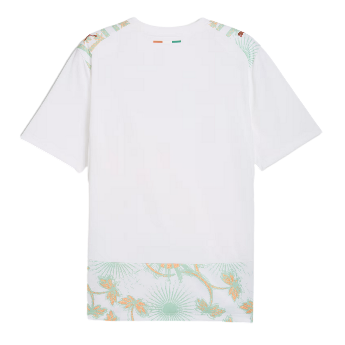 A back view of a white soccer jersey featuring a small orange, white, and green flag on the back of the neck. Light green and gold floral patterns decorate the shoulders and bottom hem, with gold Puma logos on each shoulder.