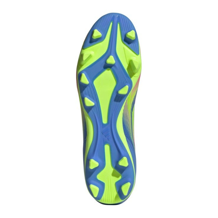 The underside of a soccer cleat featuring a vibrant blue and neon green soleplate with a variety of shaped studs for traction.