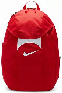 Red Nike backpack with a white swoosh logo on a central white panel, featuring multiple zippered compartments and a top handle.
