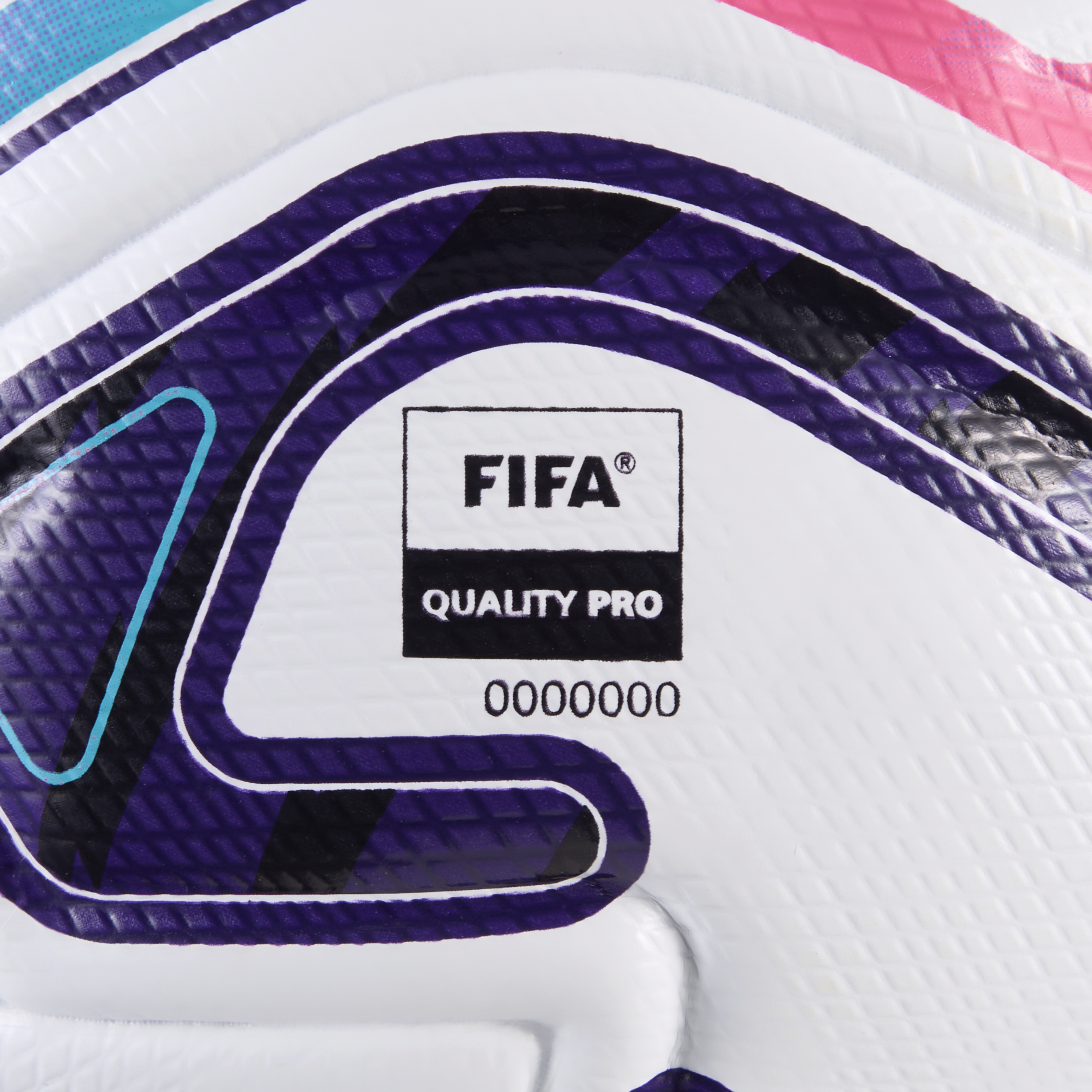 Close-up of a textured white soccer ball featuring a "FIFA QUALITY PRO" logo and bold purple, pink, and cyan patterns.