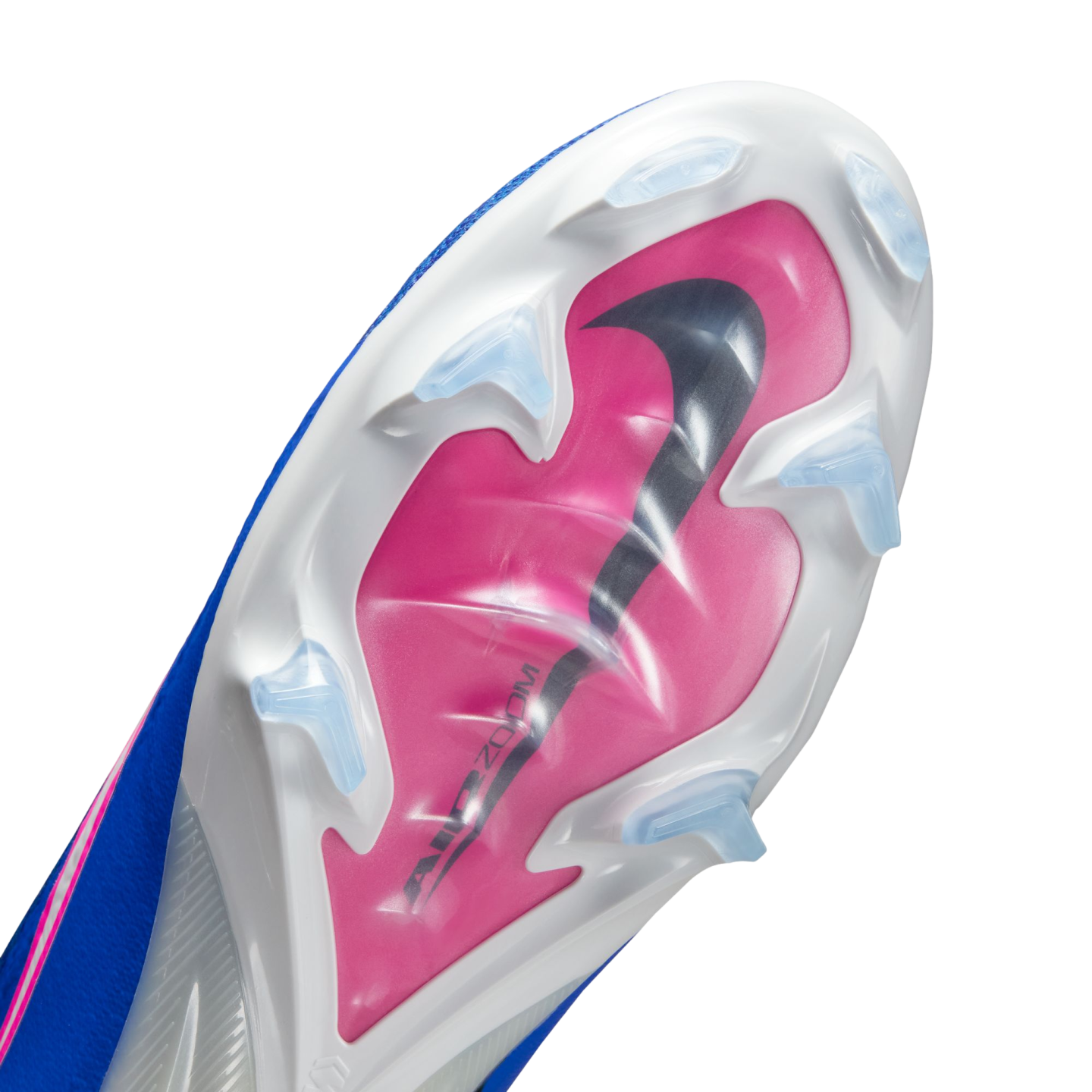 Underside of a blue and white Nike soccer cleat with a pink soleplate, a large black Nike swoosh, and clear triangular studs against a black background.