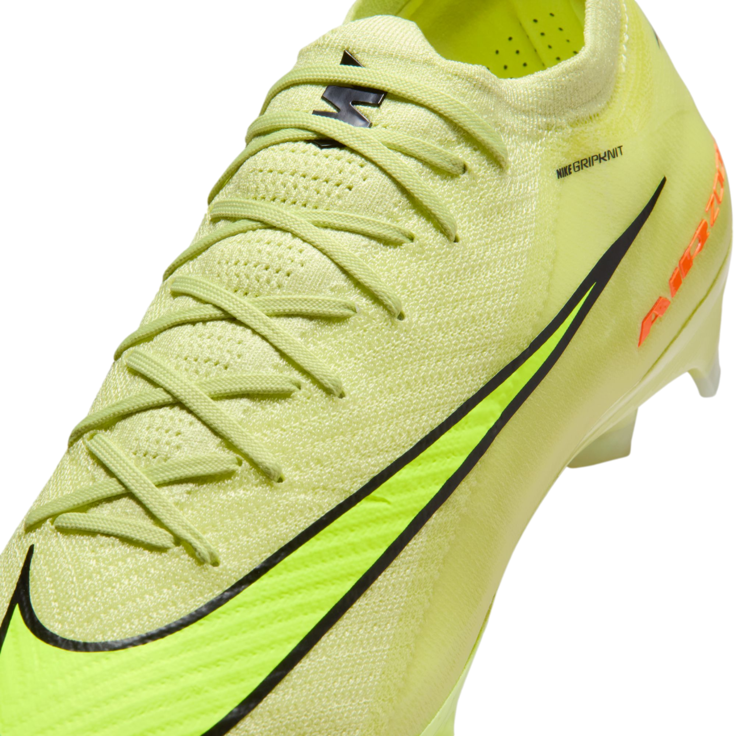 Close-up of a neon yellow Nike Gripknit soccer cleat with a black swoosh and textured upper.