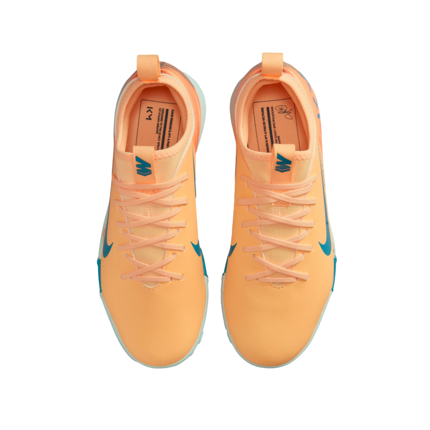 Top-down view of bright orange Nike Mercurial soccer shoes with teal accents and Kylian Mbappé branding against a black background.