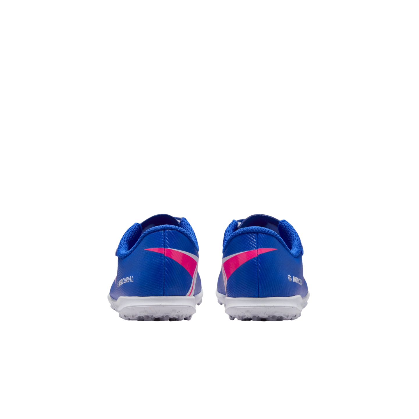 Rear view of blue Nike Mercurial turf shoes with pink accents and white outsoles, set against a solid black background.