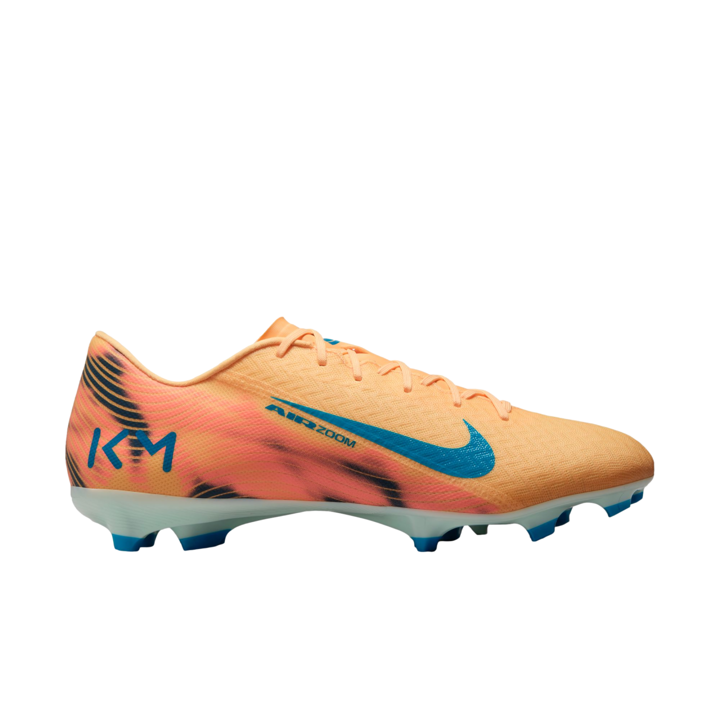 Peach-colored Nike Air Zoom KM soccer cleat with black wavy patterns, a blue swoosh, and blue studs, shown against a black background.