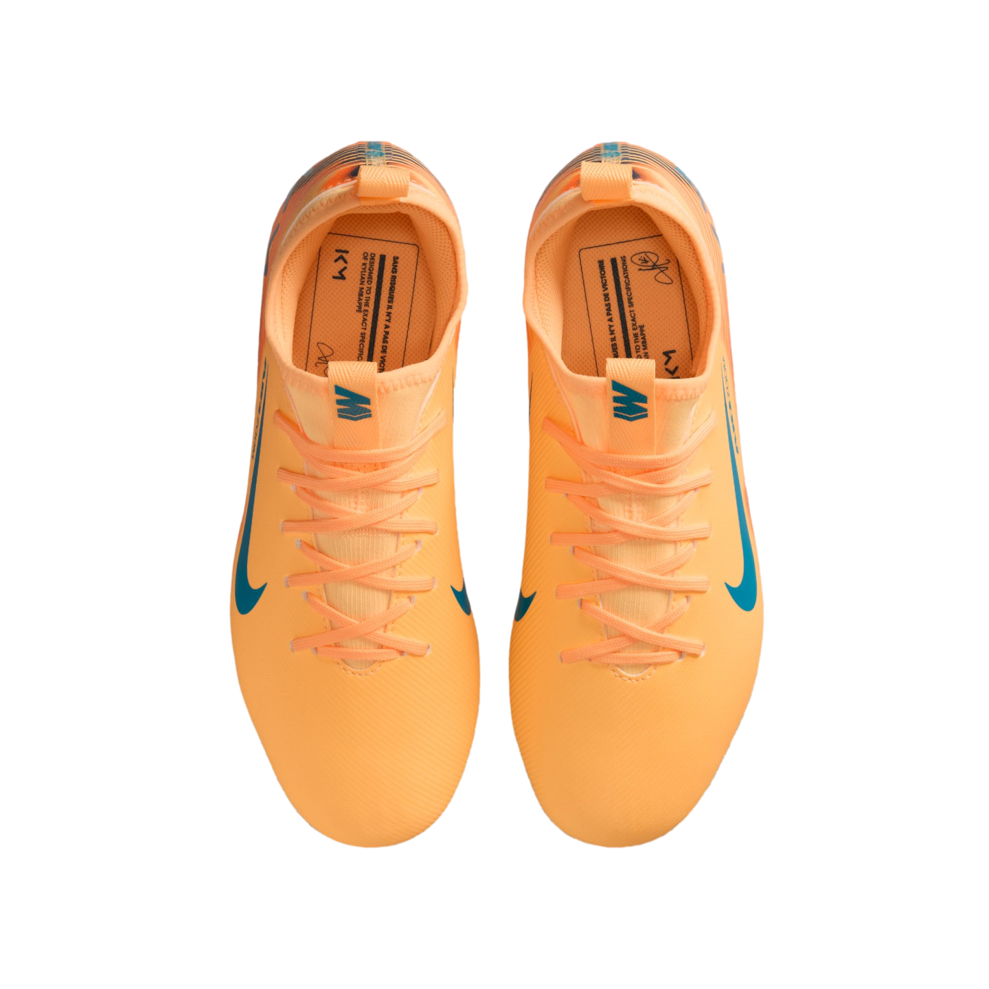 Top-down view of bright orange Nike soccer cleats with blue accents and Kylian Mbappé's "KM" branding on a black background.