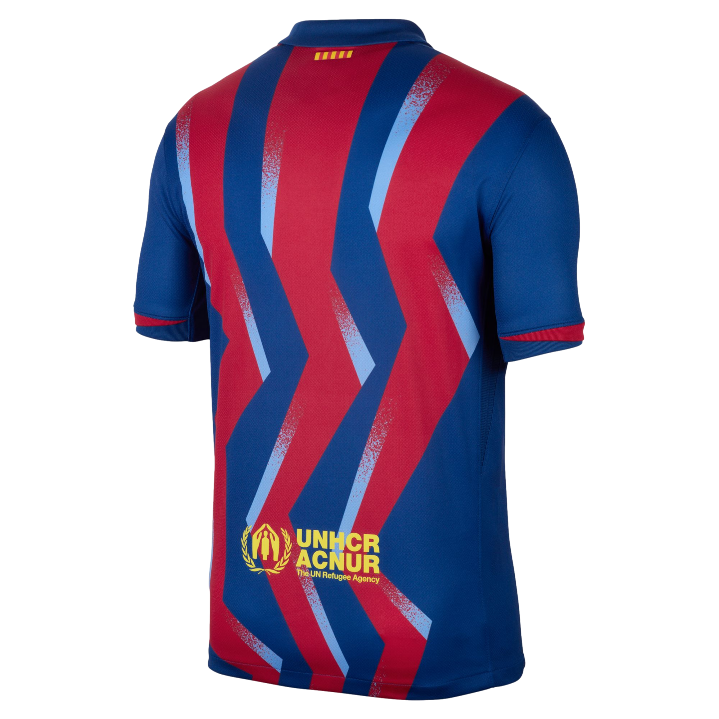 Back view of a blue soccer jersey with red and light blue zig-zag patterns. A yellow UNHCR ACNUR logo is printed at the bottom.