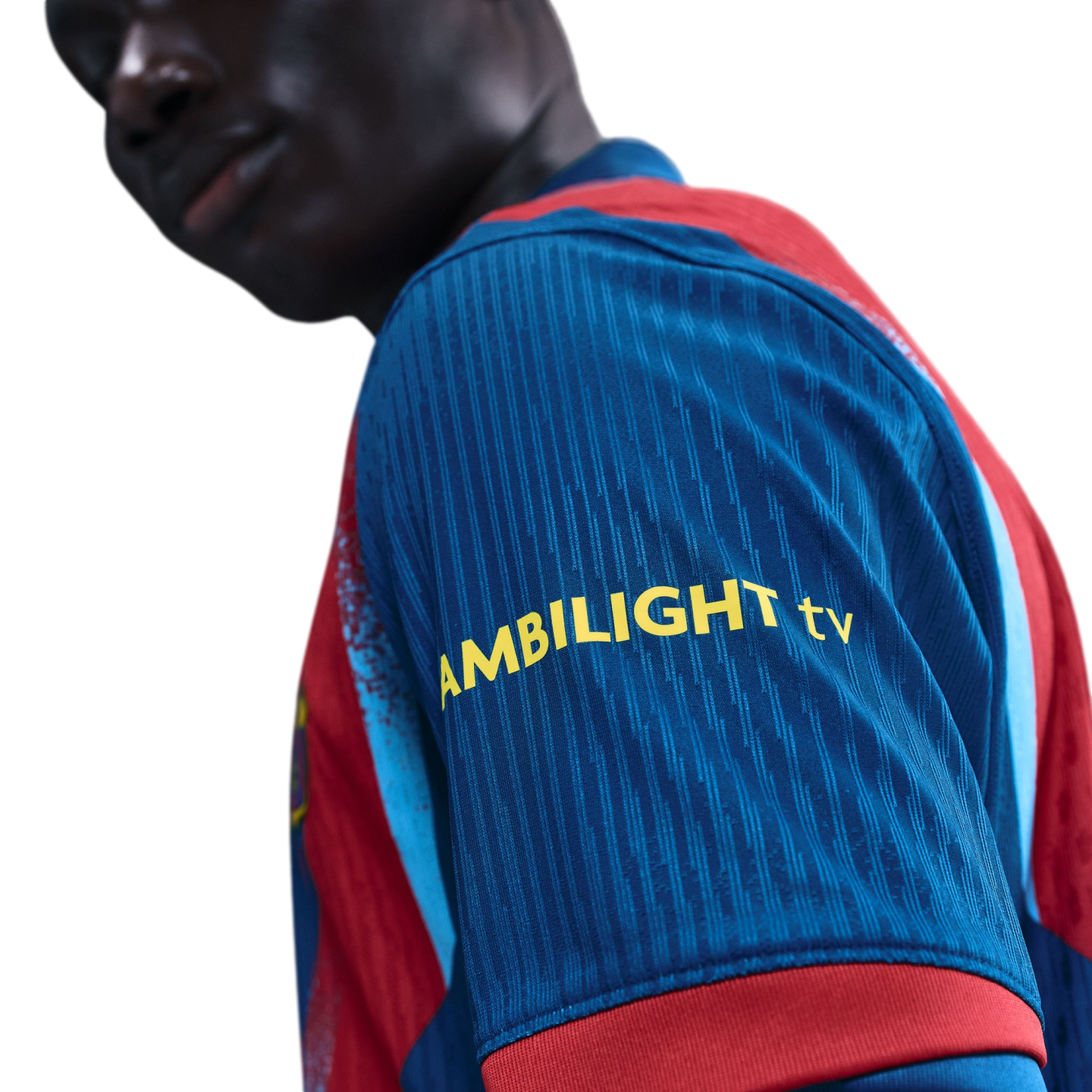 Close-up of a person wearing a blue and red sports jersey with "AMBILIGHT tv" printed in yellow on the sleeve. Solid black background.