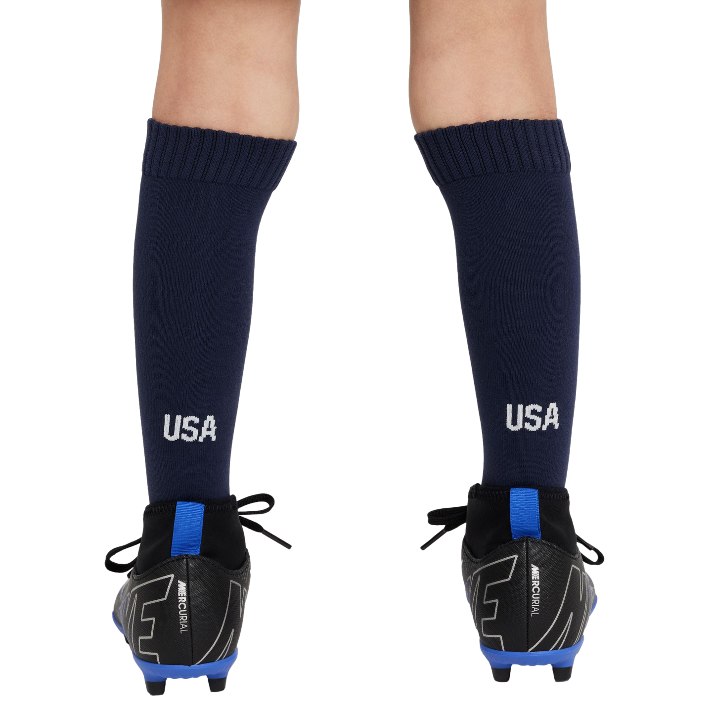 Rear view of a person's lower legs wearing navy blue USA soccer socks and black Nike Mercurial cleats with bright blue accents against a white background.