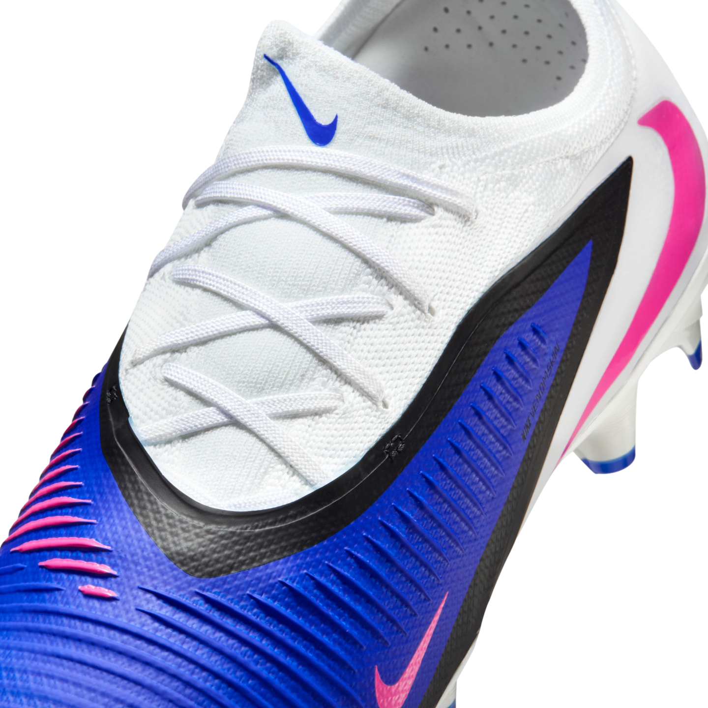 A close-up of a white and blue Nike soccer cleat with pink accents, featuring white laces and a ribbed blue texture.