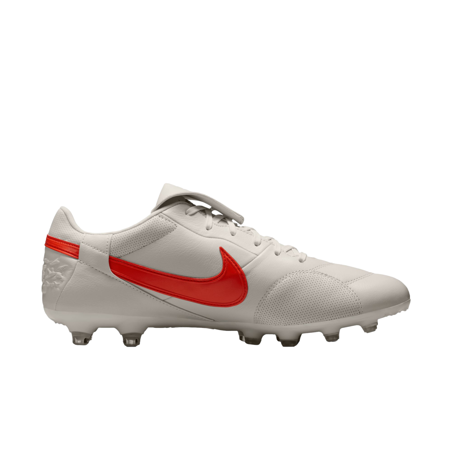 White Nike soccer cleat with a red swoosh against a black background. Features include a perforated leather upper and clear studs.