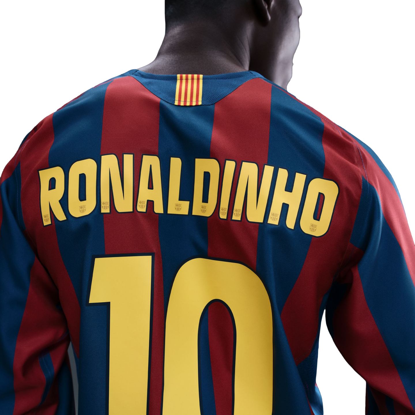 Back of a red and blue striped FC Barcelona jersey with "RONALDINHO" and number "10" in yellow. A small Catalonian flag detail is on the neck.