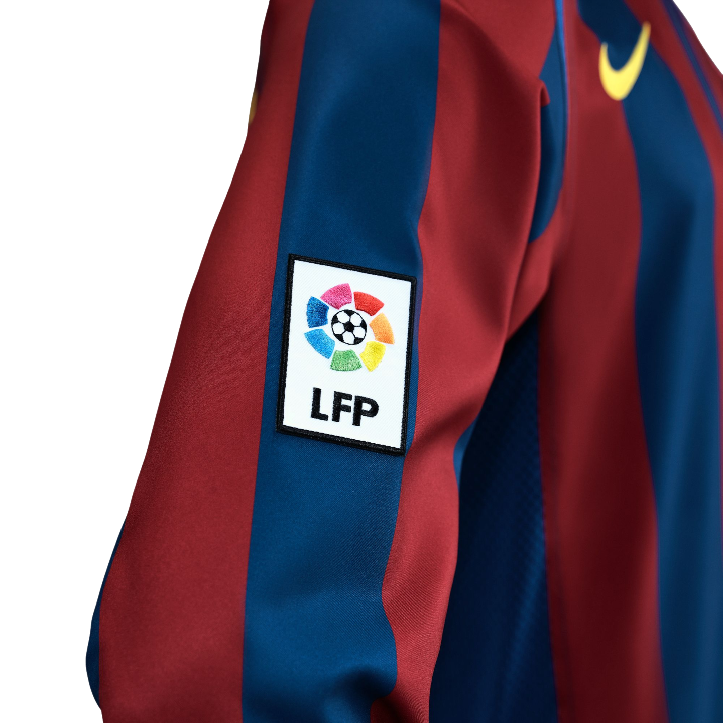 Close-up of a red and blue striped soccer jersey with an LFP league patch on the sleeve and a yellow Nike logo on the chest.
