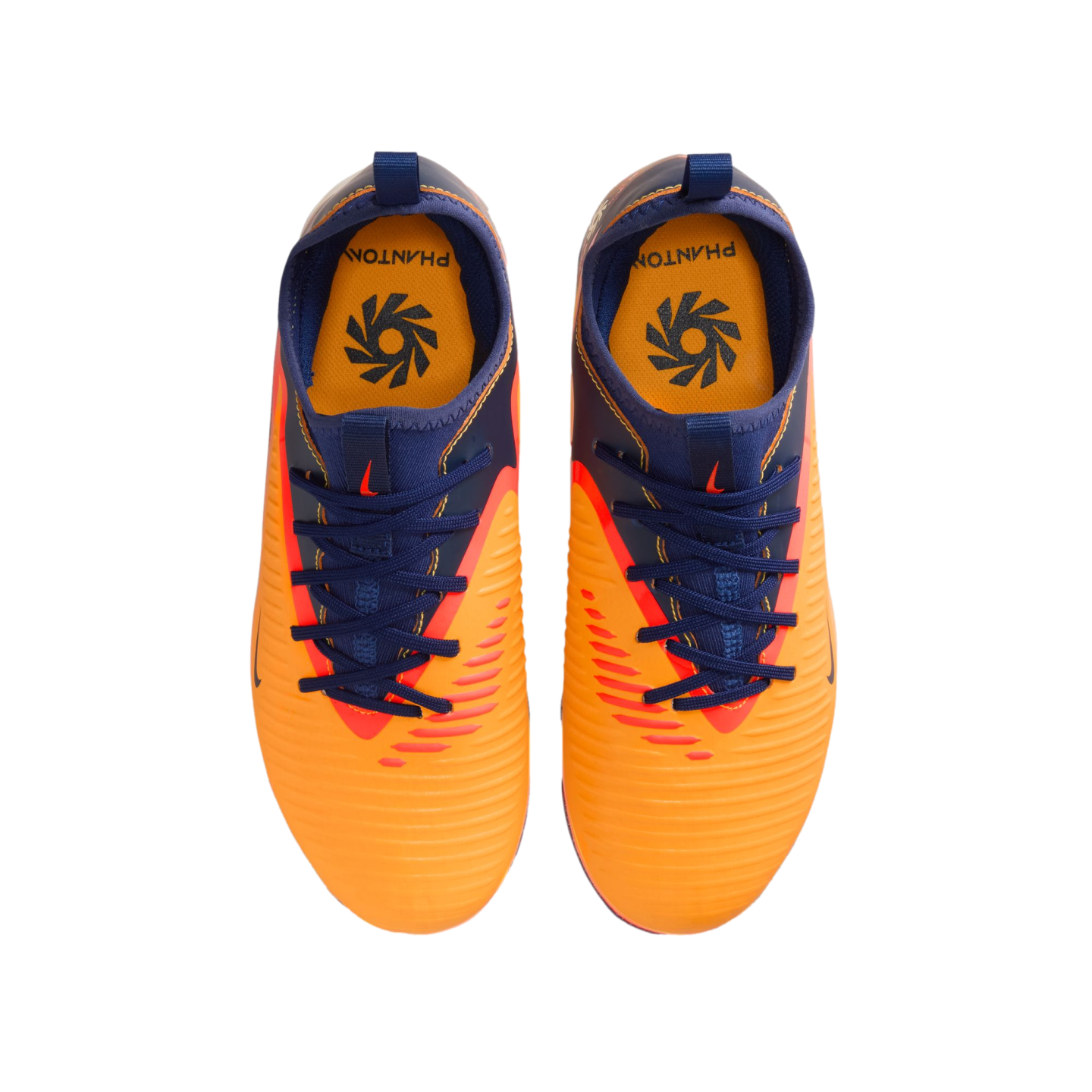 Top-down view of a pair of bright orange and navy blue Nike Phantom soccer cleats on a black background.
