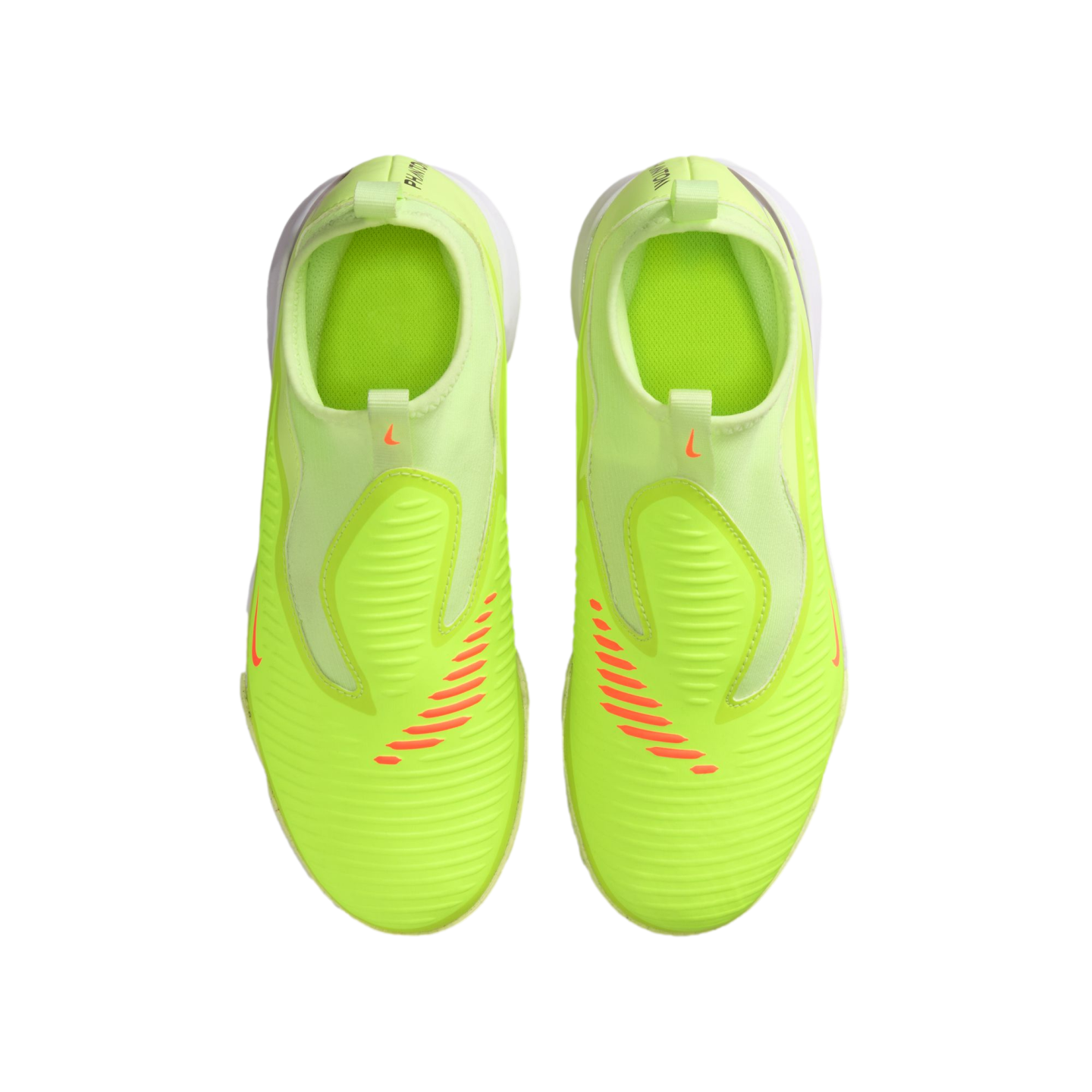 A top-down view of neon yellow Nike soccer cleats with orange accents and a slip-on design, set against a solid black background.