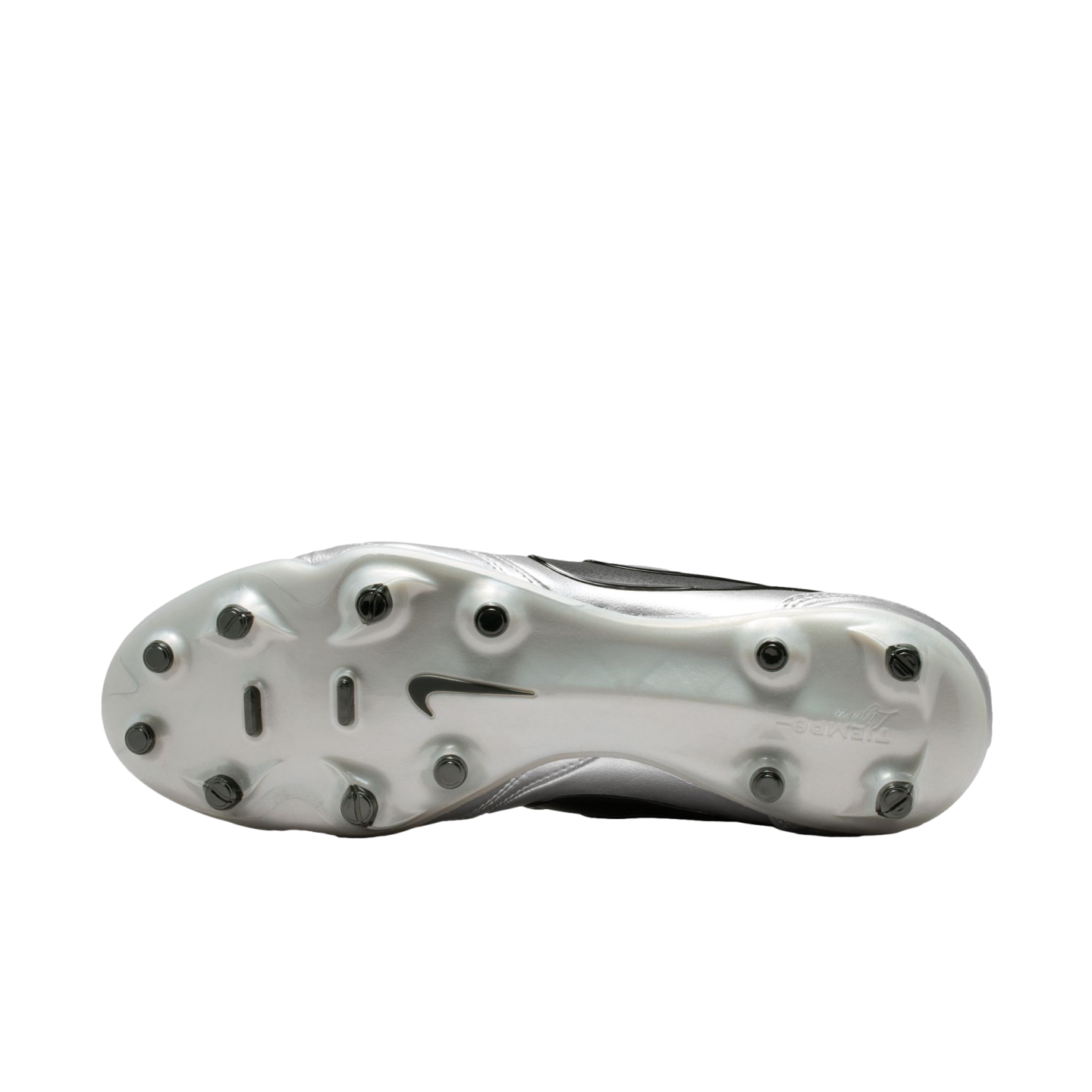 A bottom-up view of the silver soleplate of a Nike soccer cleat with black studs, shown against a solid black background.