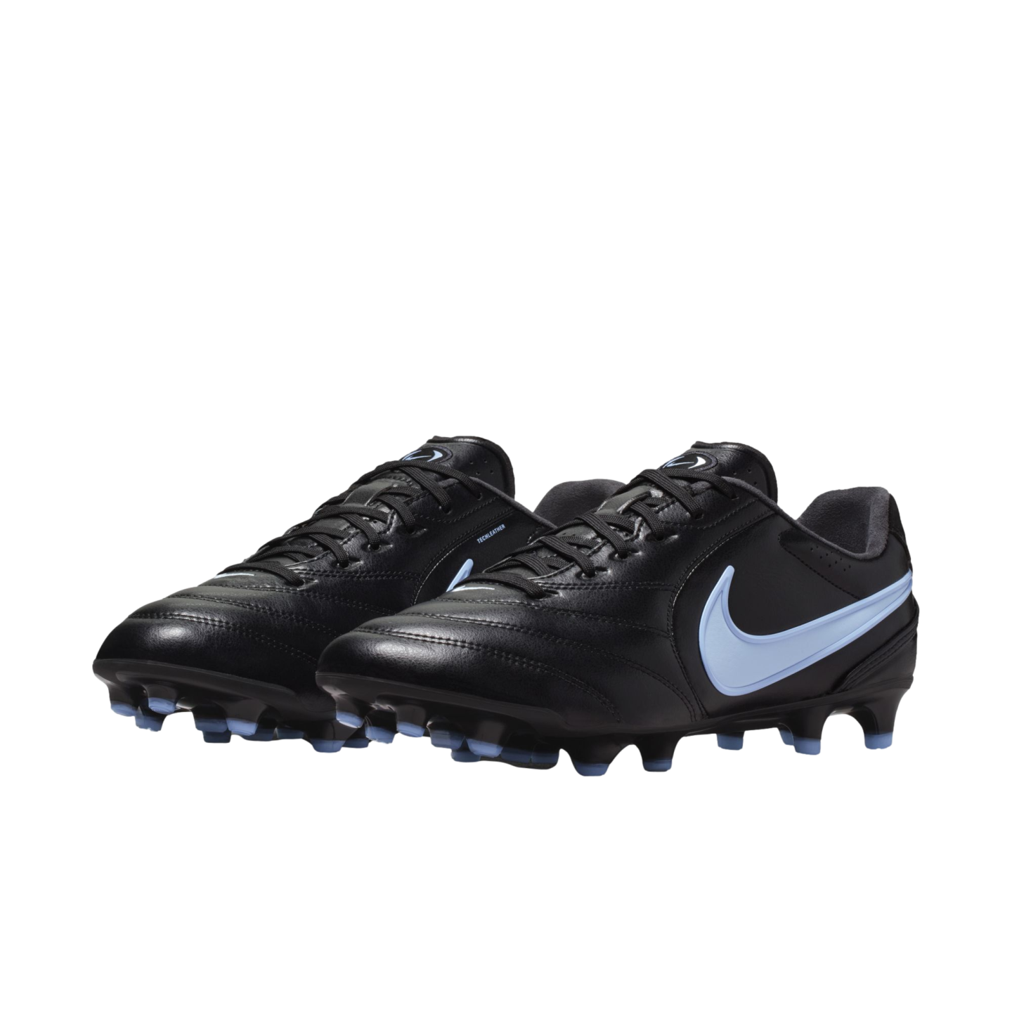 A pair of black Nike soccer cleats with light blue swooshes and matching studs, shown against a solid black background.