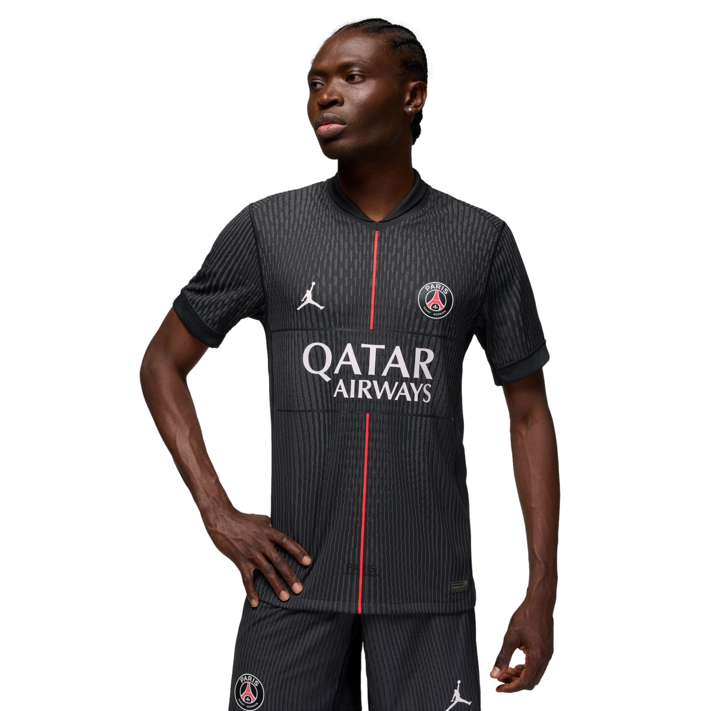 A person wearing a dark grey pinstriped Paris Saint-Germain jersey with a red vertical stripe down the center, set against a black background.