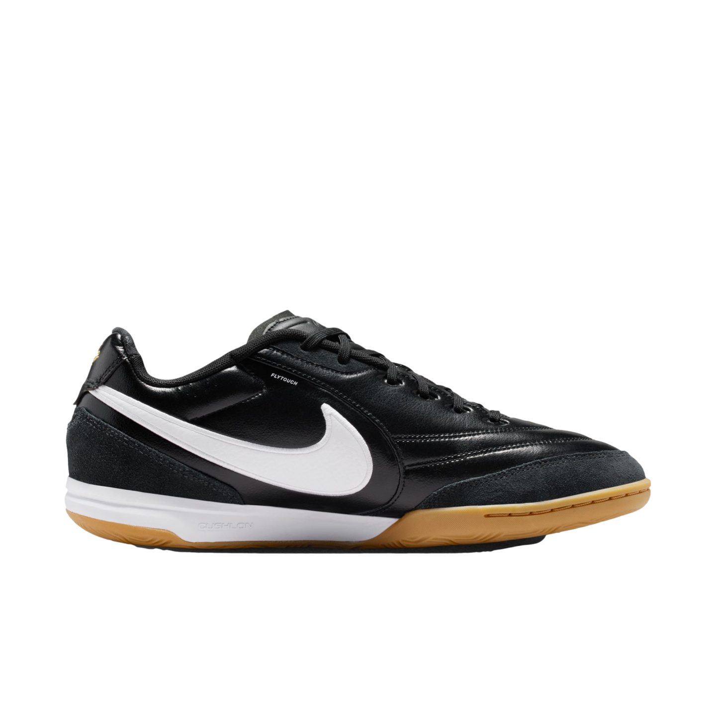 Profile view of a black Nike indoor soccer shoe with a white swoosh, white midsole, and gum outsole, set against a black background.