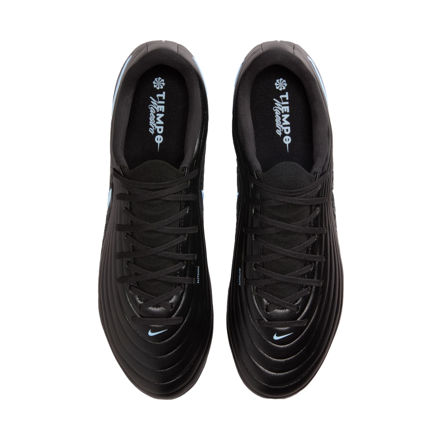 Top-down view of a pair of black Nike Tiempo Maestro soccer cleats with light blue accents, positioned against a solid black background.