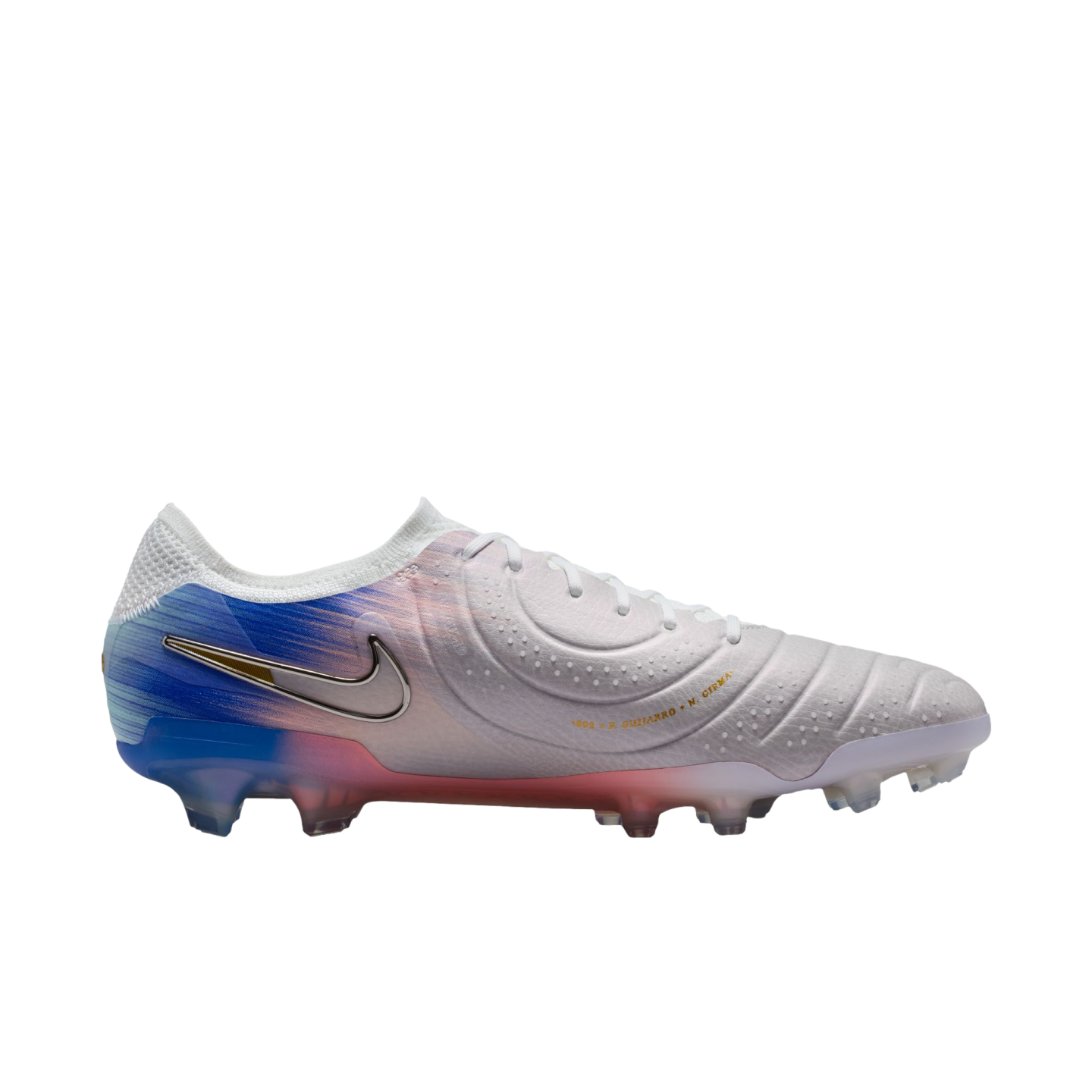 A white Nike soccer cleat with a silver swoosh and a blue and pink gradient on the heel and soleplate, set against a black background.