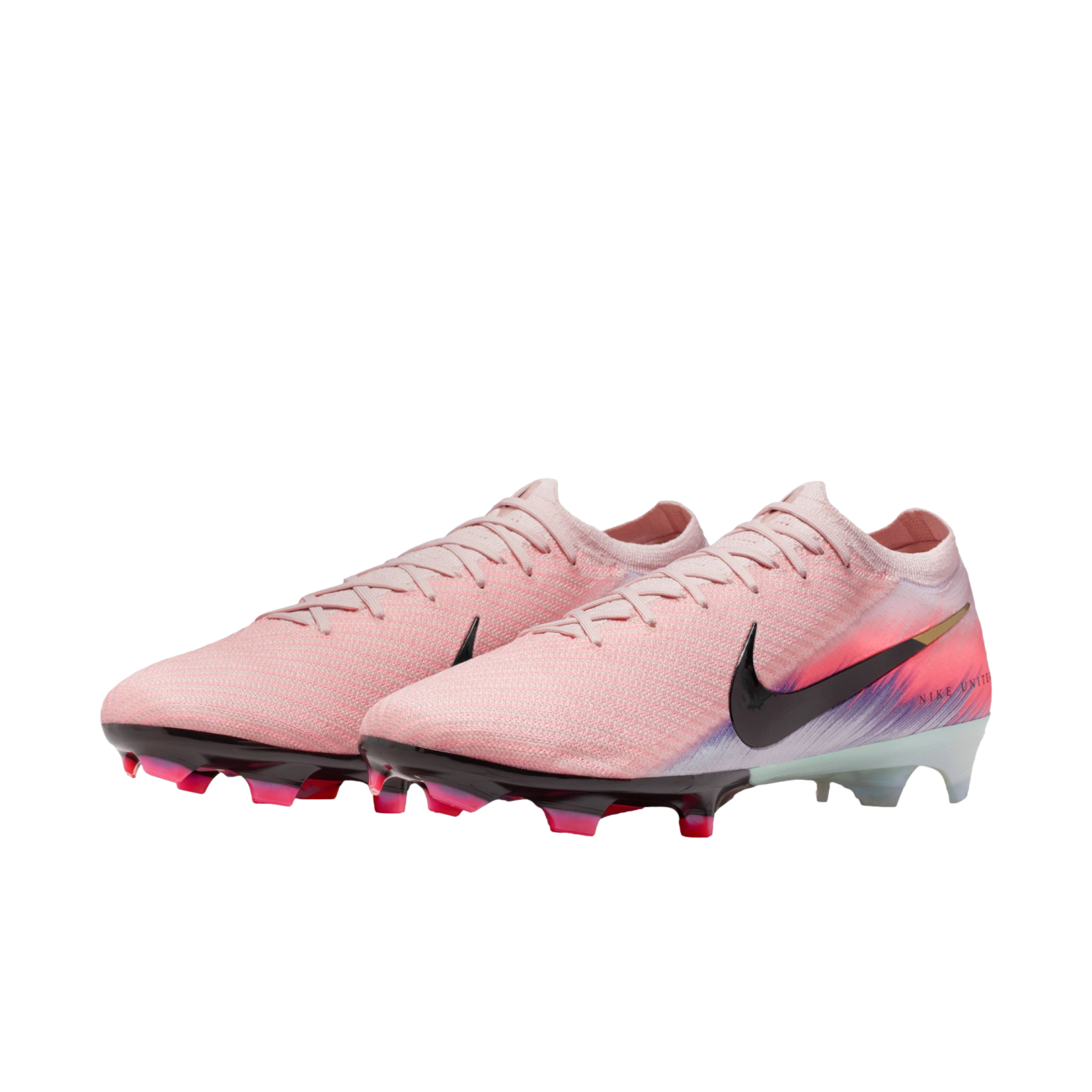 Pink Nike soccer cleats with black swooshes and colorful heel designs, displayed on a solid black background.
