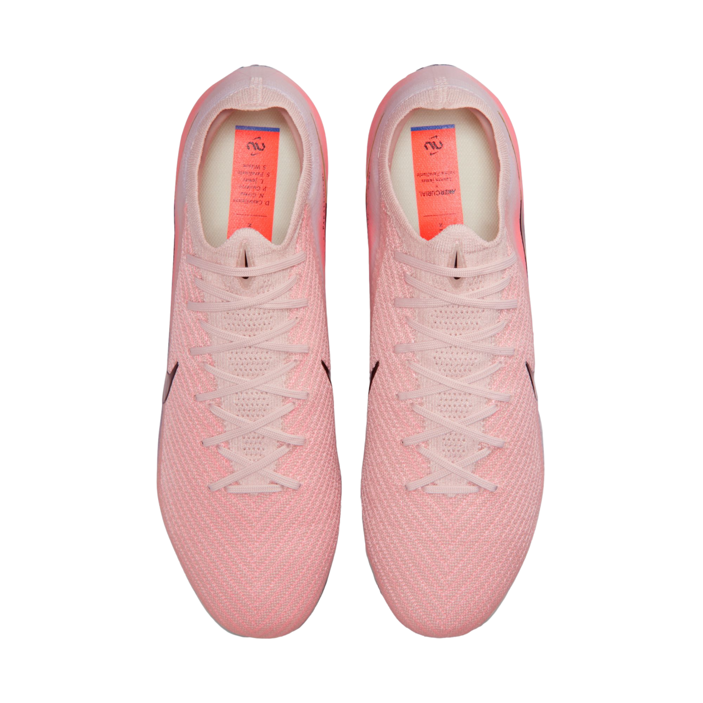 Top-down view of light pink Nike Mercurial soccer cleats with a textured knit upper and matching laces, set against a black background.