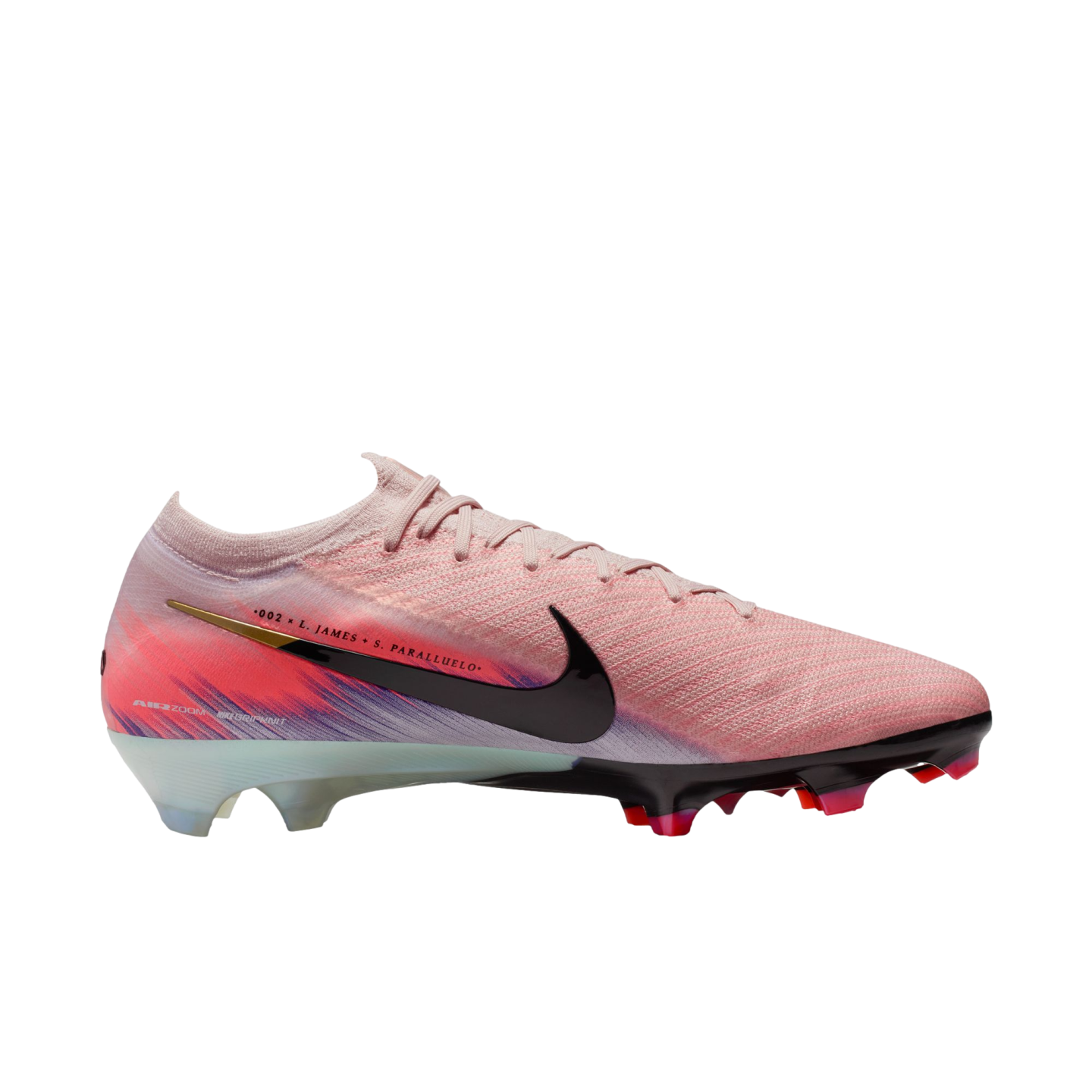 A profile of a light pink Nike soccer cleat with a black swoosh, vibrant pink and purple heel graphics, and colorful studs. Set against a plain black background.
