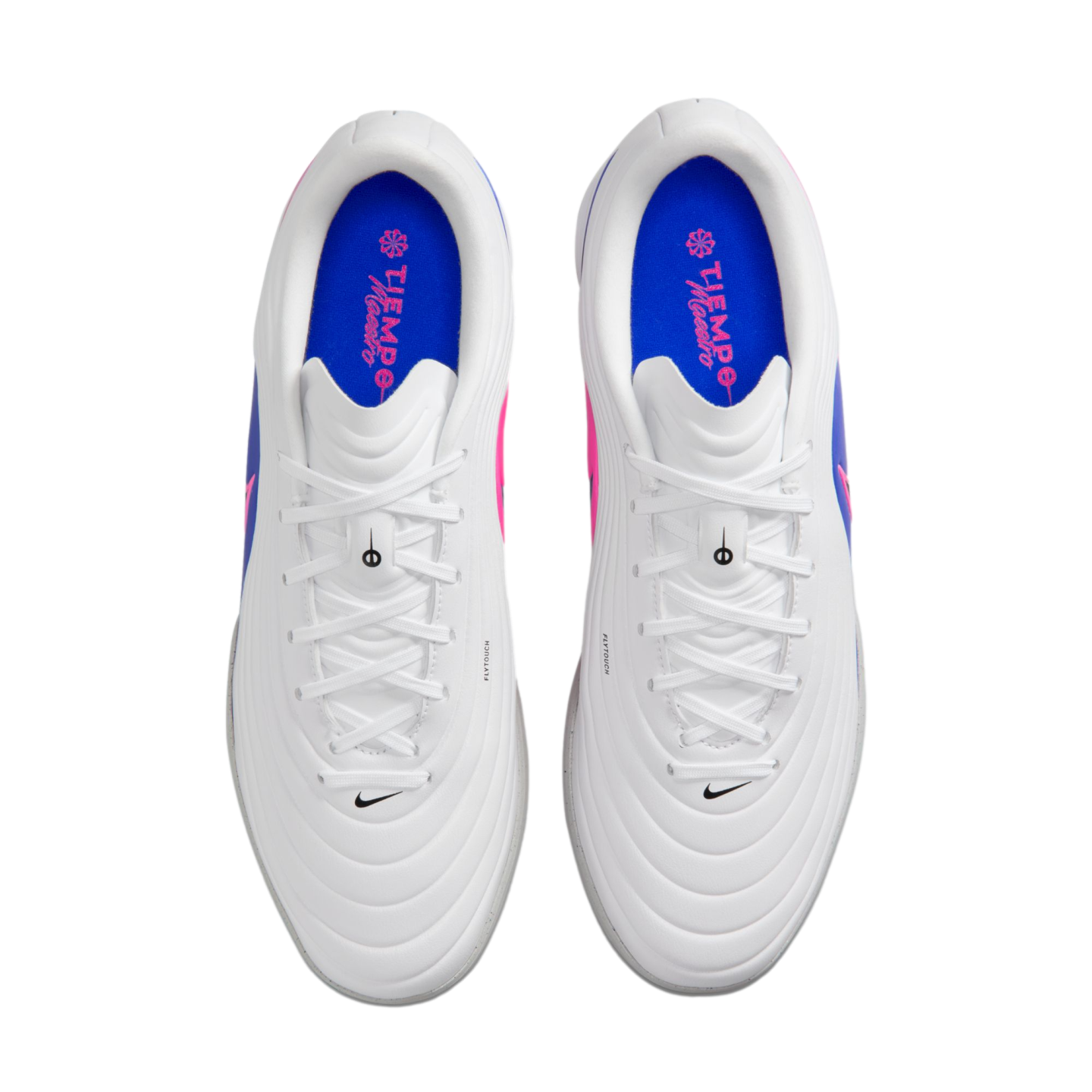 Top-down view of white Nike Tiempo Maestro soccer shoes with blue insoles and pink accents.