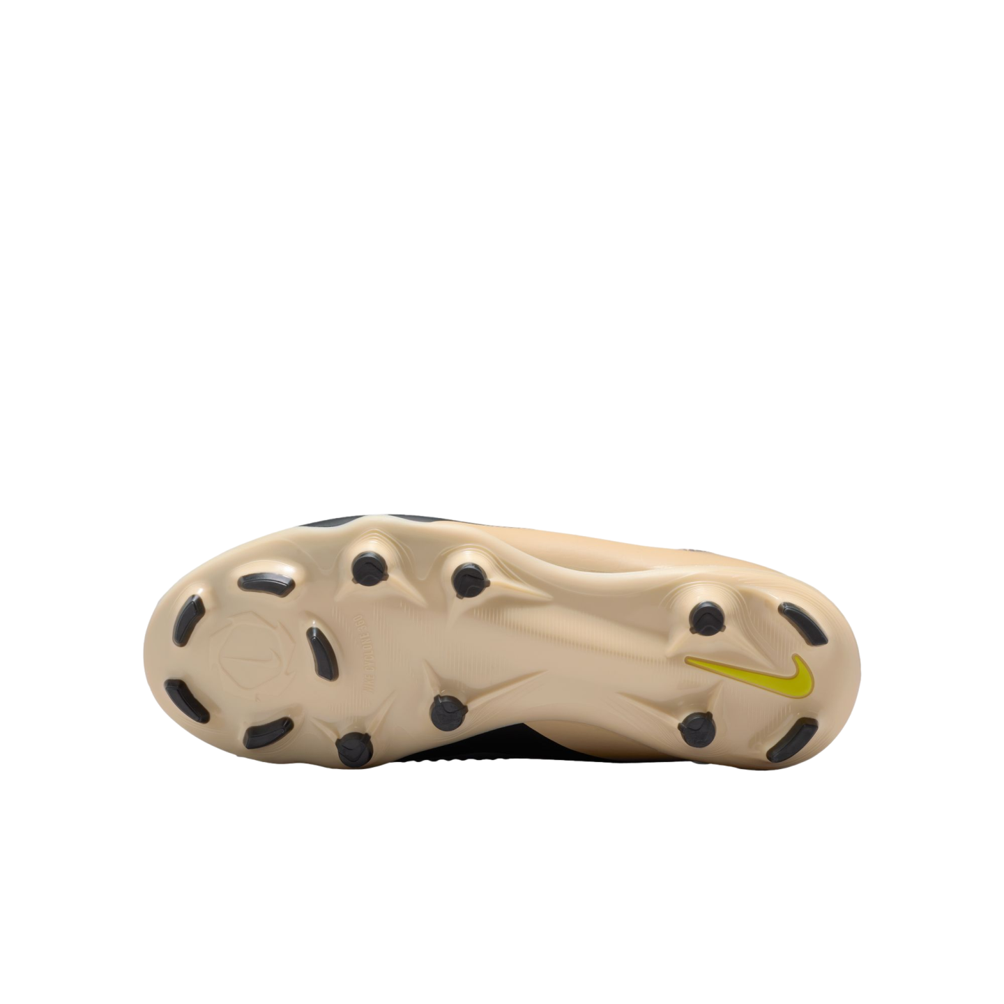 Underside of a beige Nike soccer cleat featuring black studs and a small neon green swoosh on the heel against a black background.