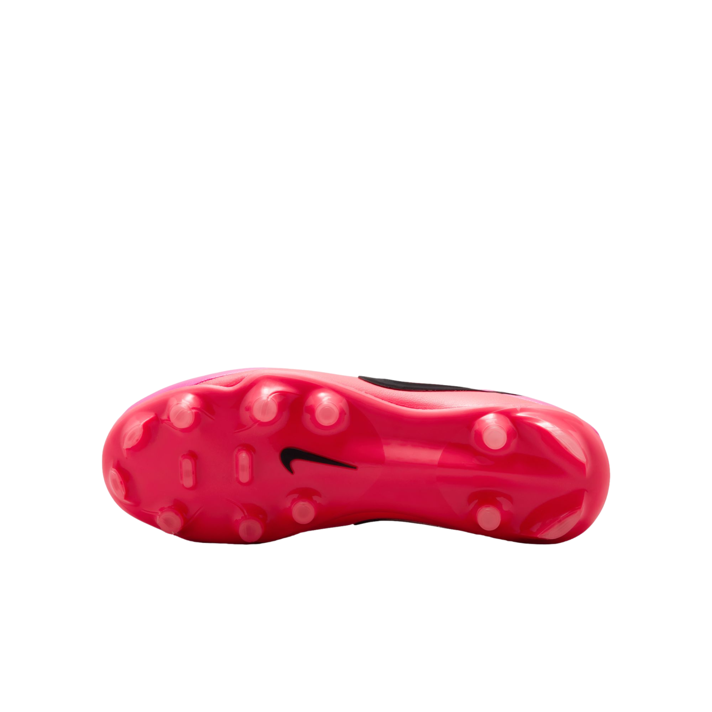 Bottom view of a pink Nike soccer cleat, featuring several rounded studs and a black Nike swoosh logo in the center.