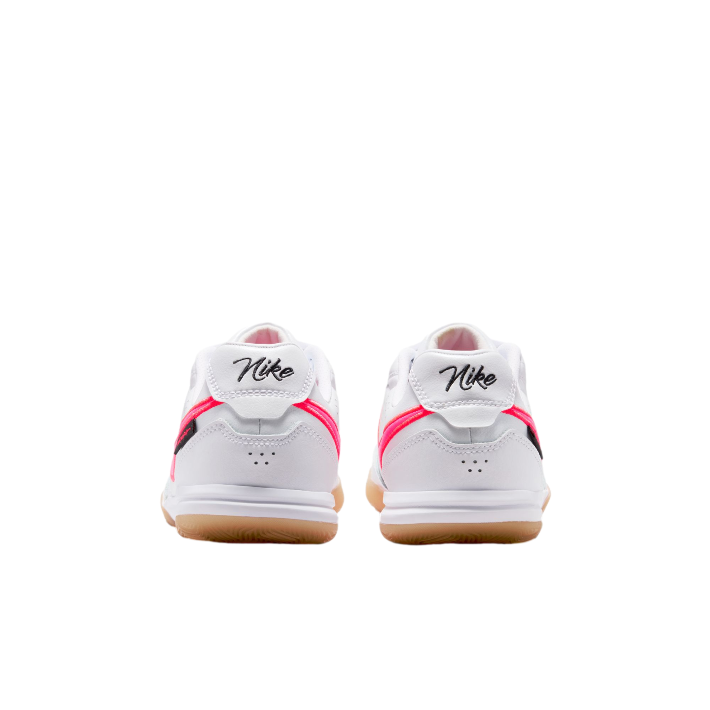 Rear view of a pair of white Nike sneakers with pink accents, gum rubber soles, and script "Nike" branding on the heels.