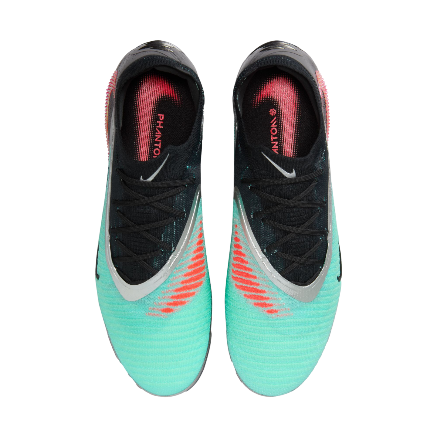 Top-down view of a pair of teal and black Nike Phantom soccer cleats featuring silver trim and bright orange graphic details on a white background.