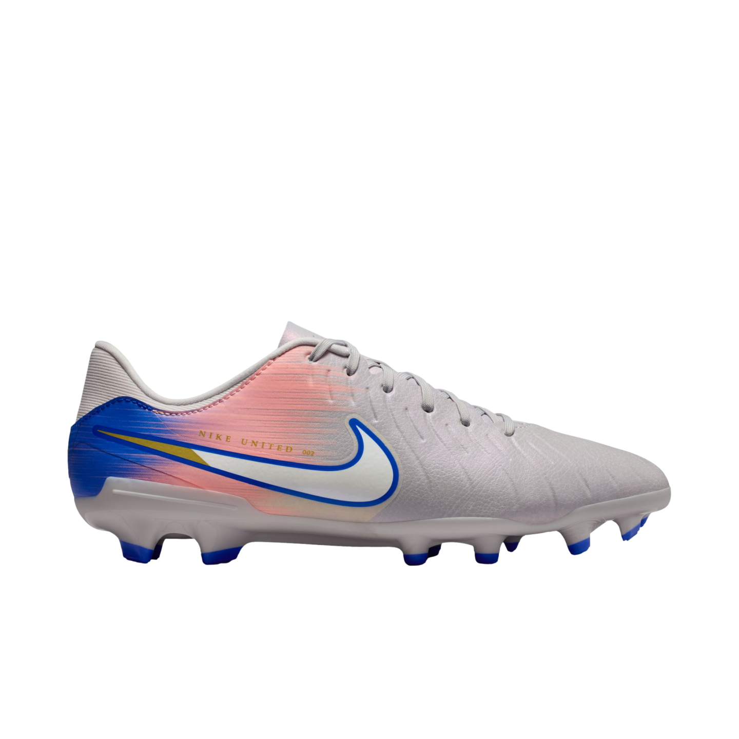 Side view of a light gray Nike soccer cleat with a pink and blue gradient heel, a white swoosh with blue trim, and blue studs, against a black background.