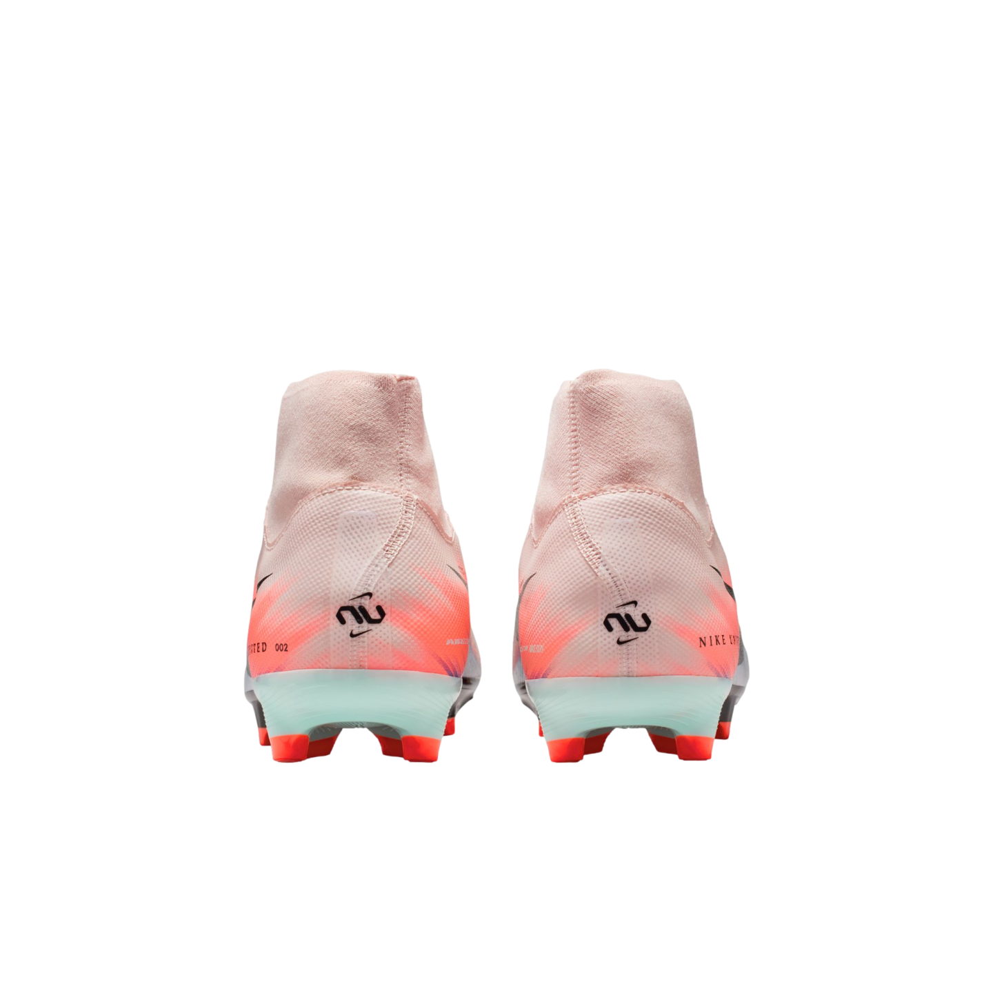 Rear view of two pink Nike soccer cleats with orange and black accents, featuring high-top ankle collars and bright orange studs.