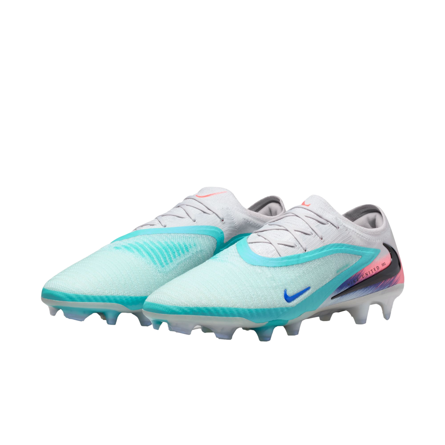 A pair of Nike soccer cleats in light blue, white, and teal with pink heel accents, shown on a solid black background.