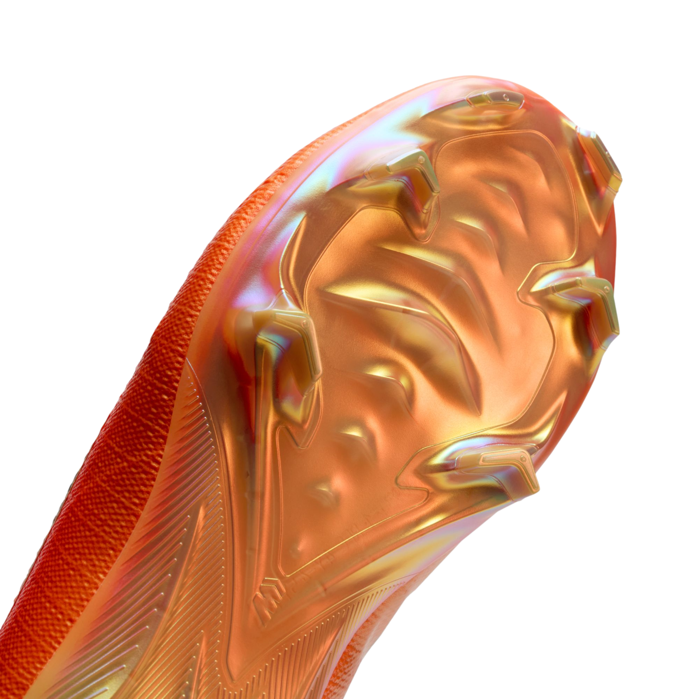 Close-up of an iridescent orange and gold soccer boot soleplate, showing chevron studs and a textured upper against a black background.