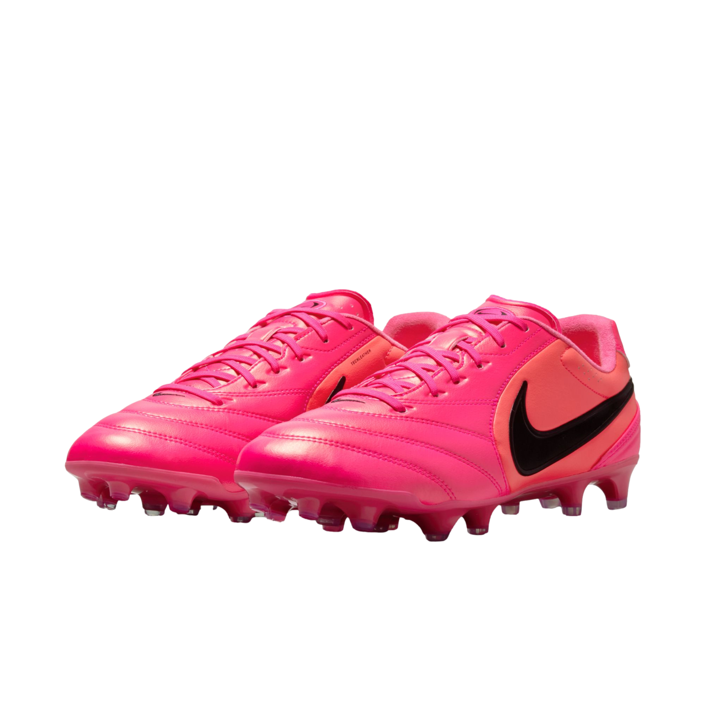 A pair of vibrant pink Nike soccer cleats with black swoosh logos, shown against a white background.