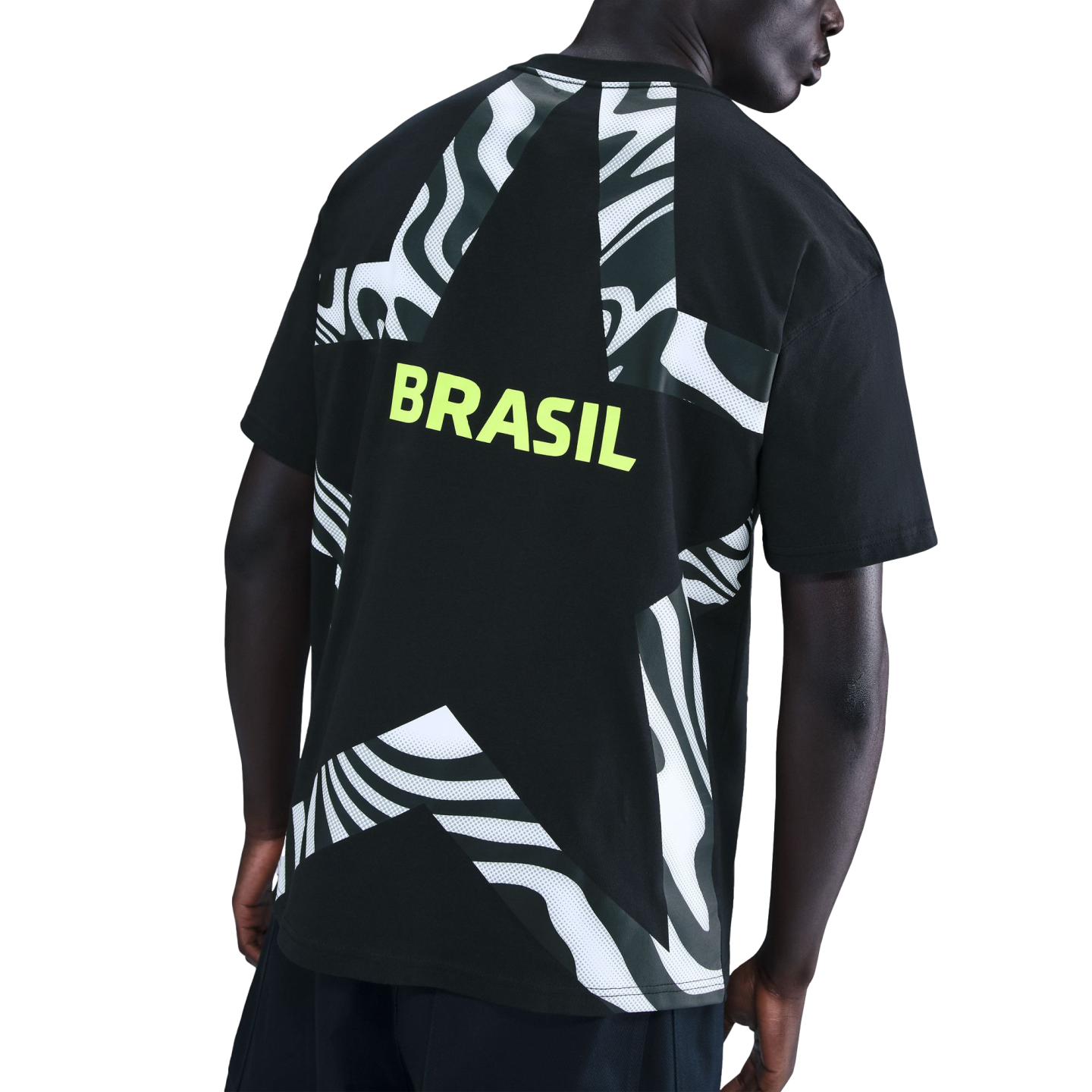 Back view of a person wearing a black t-shirt with a large star design, white wavy patterns, and "BRASIL" in neon yellow text.
