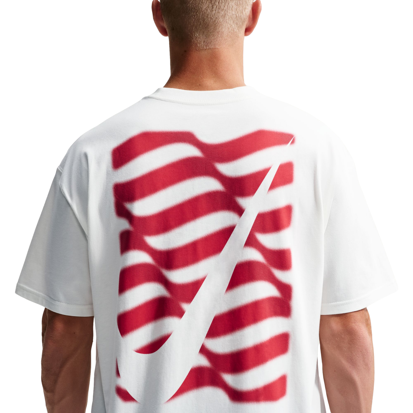 Rear view of a person in a white t-shirt with a red wavy striped graphic and a large white Nike swoosh on the back.