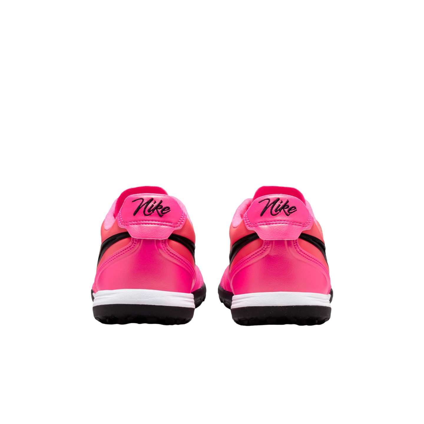 Rear view of two bright pink Nike sneakers with black script logos on the heels, white midsoles, and black outsoles against a plain white background.