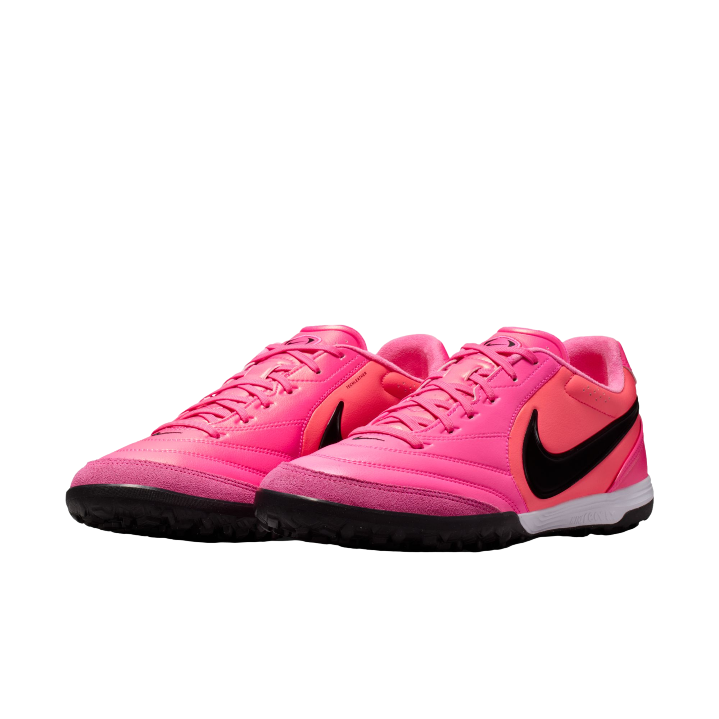 Bright pink Nike turf soccer shoes with a black swoosh and black soles on a white background.
