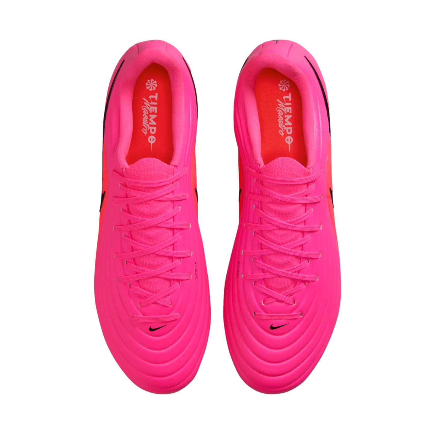 Top-down view of a pair of bright pink Nike soccer cleats with matching laces and red insoles on a white background.