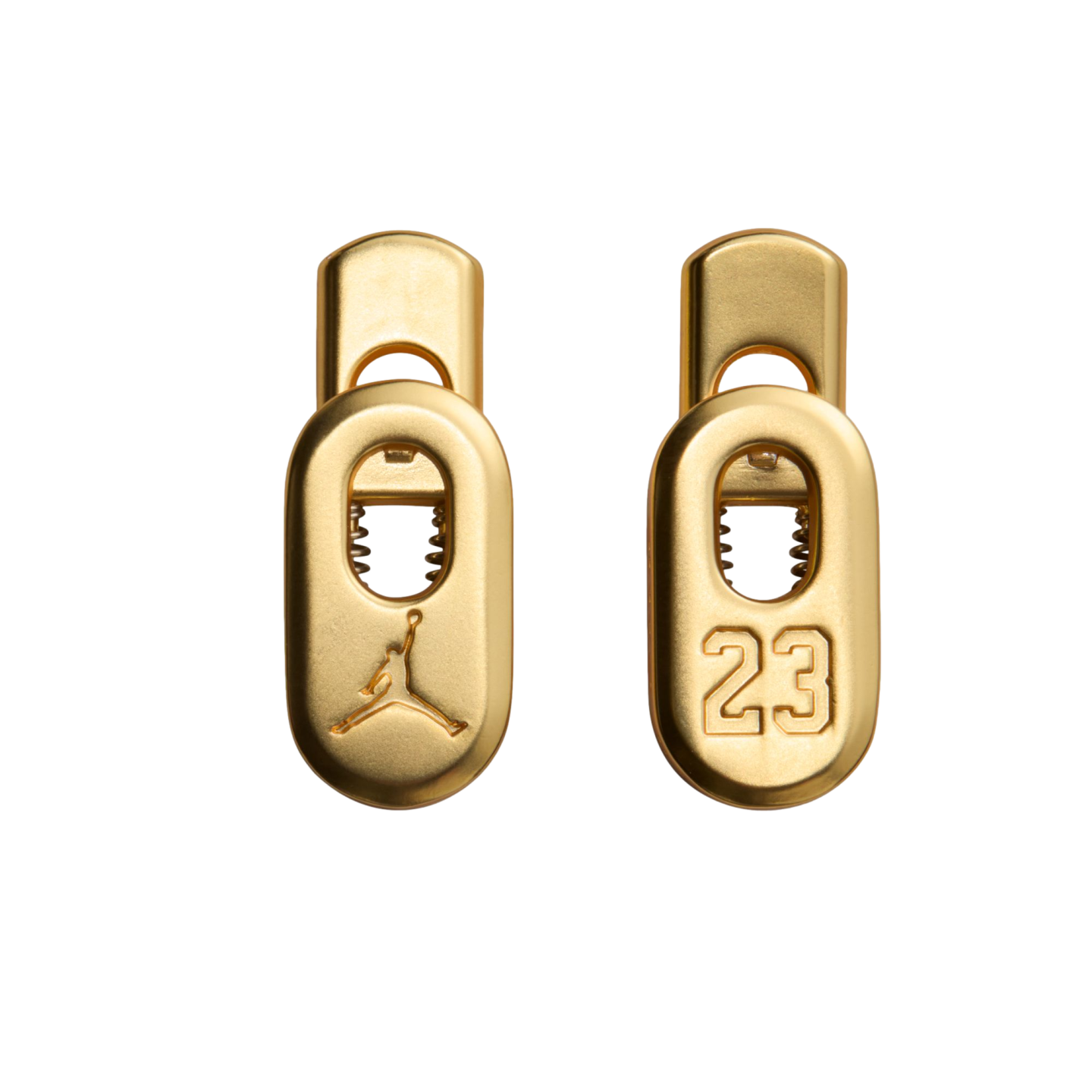 Two gold Jordan Brand lace toggles on a black background. The left features the Jumpman logo, and the right displays the number 23.