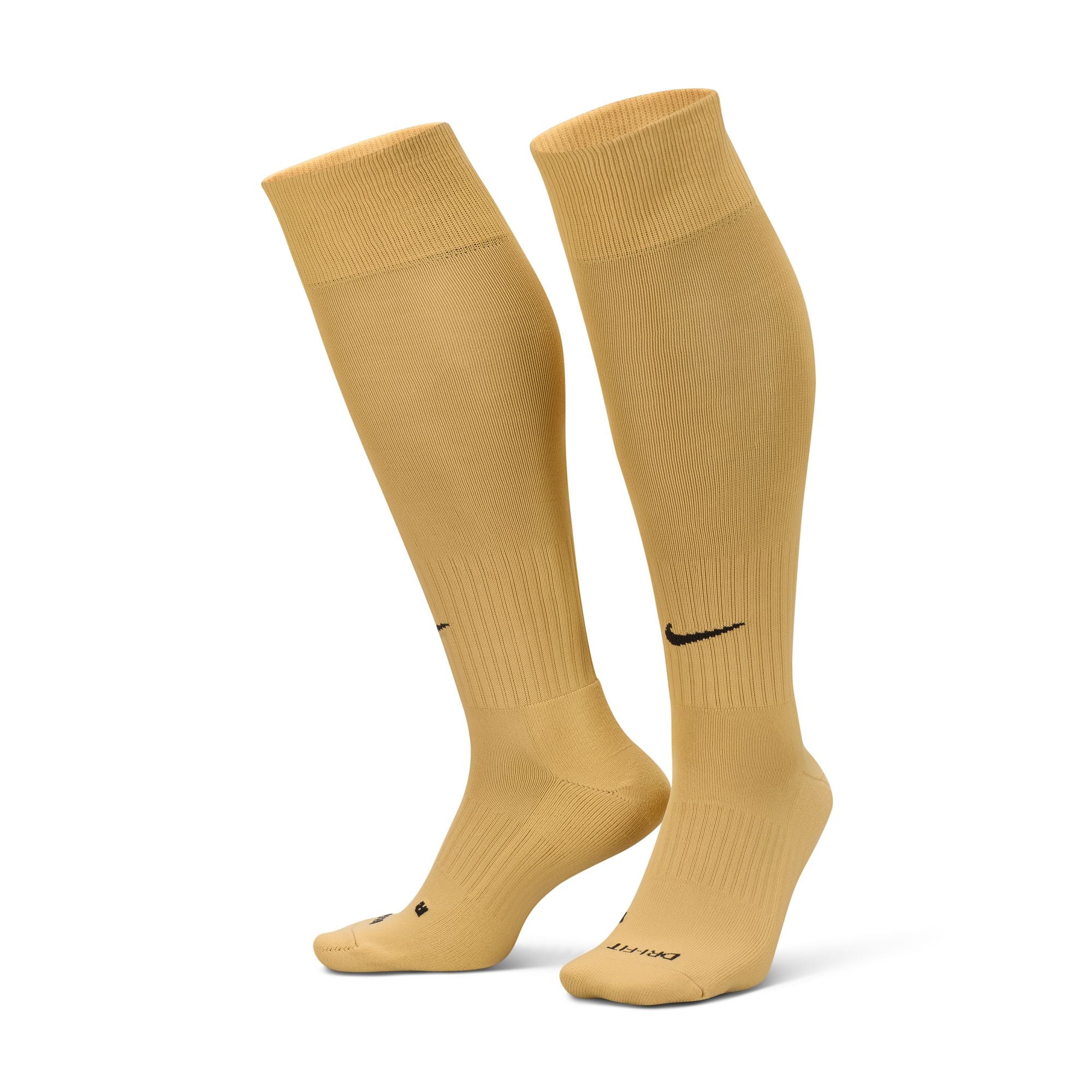 A pair of gold knee-high Nike soccer socks featuring a black swoosh logo on the front and DRI-FIT text on the footbed.