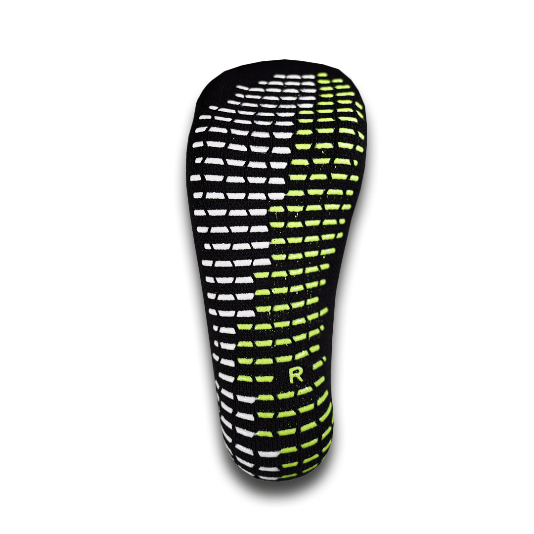 Bottom view of the For The Footballer XLR8R Pro No Slip Socks - Black, featuring white and neon green rectangular non-slip grips and an "R" indicating the right foot.