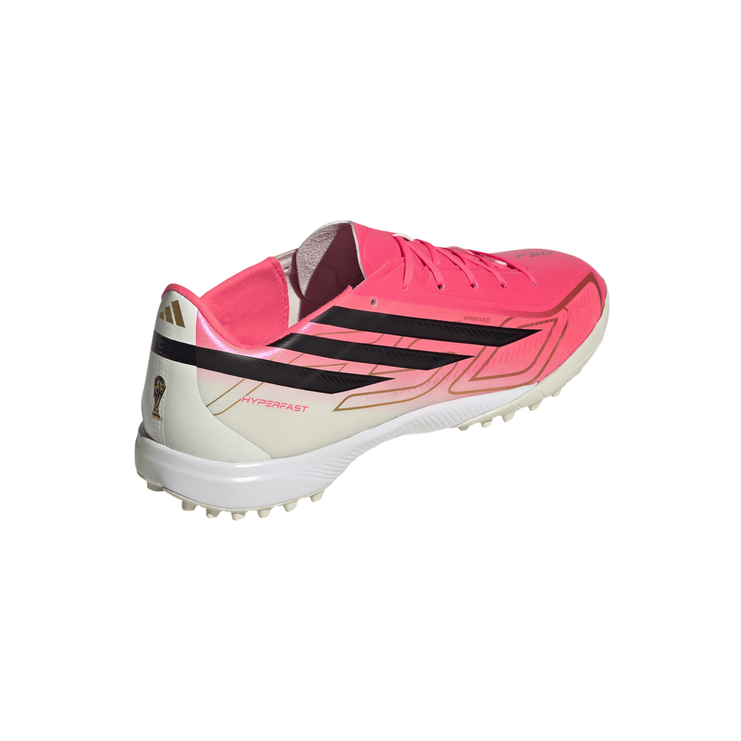 Adidas soccer turf shoe featuring a bright pink and white upper, black iconic stripes, and gold accents, including a World Cup trophy icon on the heel.